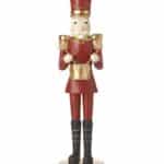 Standing nutcracker drummer soldier, in red uniform with gold drum and black boots.